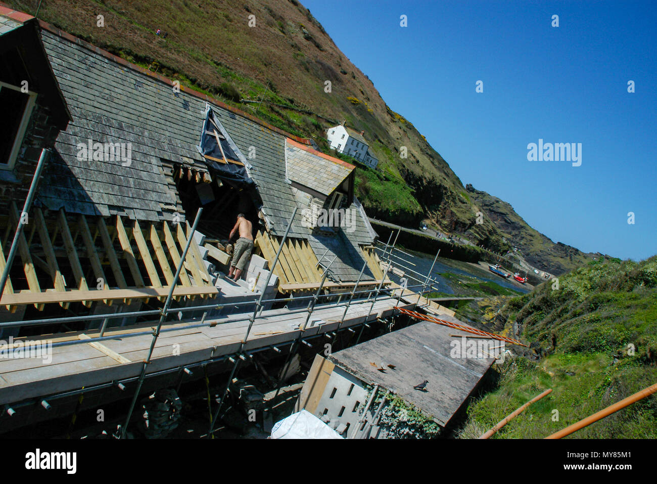 Building in Boscastle, Cornwall, being repaired after the devastating flood of 2004. Roofing repairs. River outlet and harbour. Stock Photo