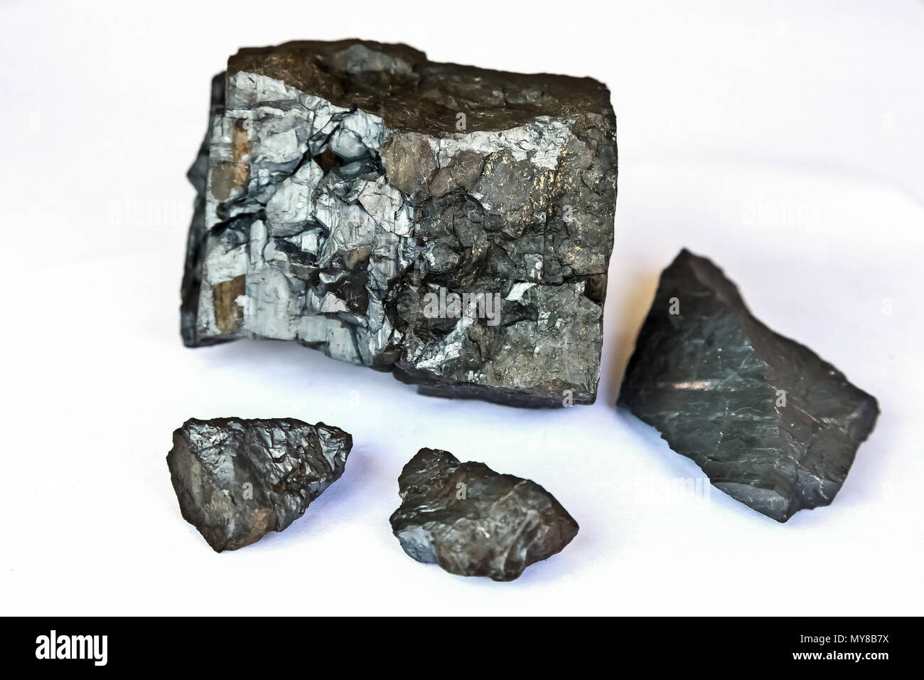 Close up of a selection of small Manganese Ore rocks on a white background Stock Photo