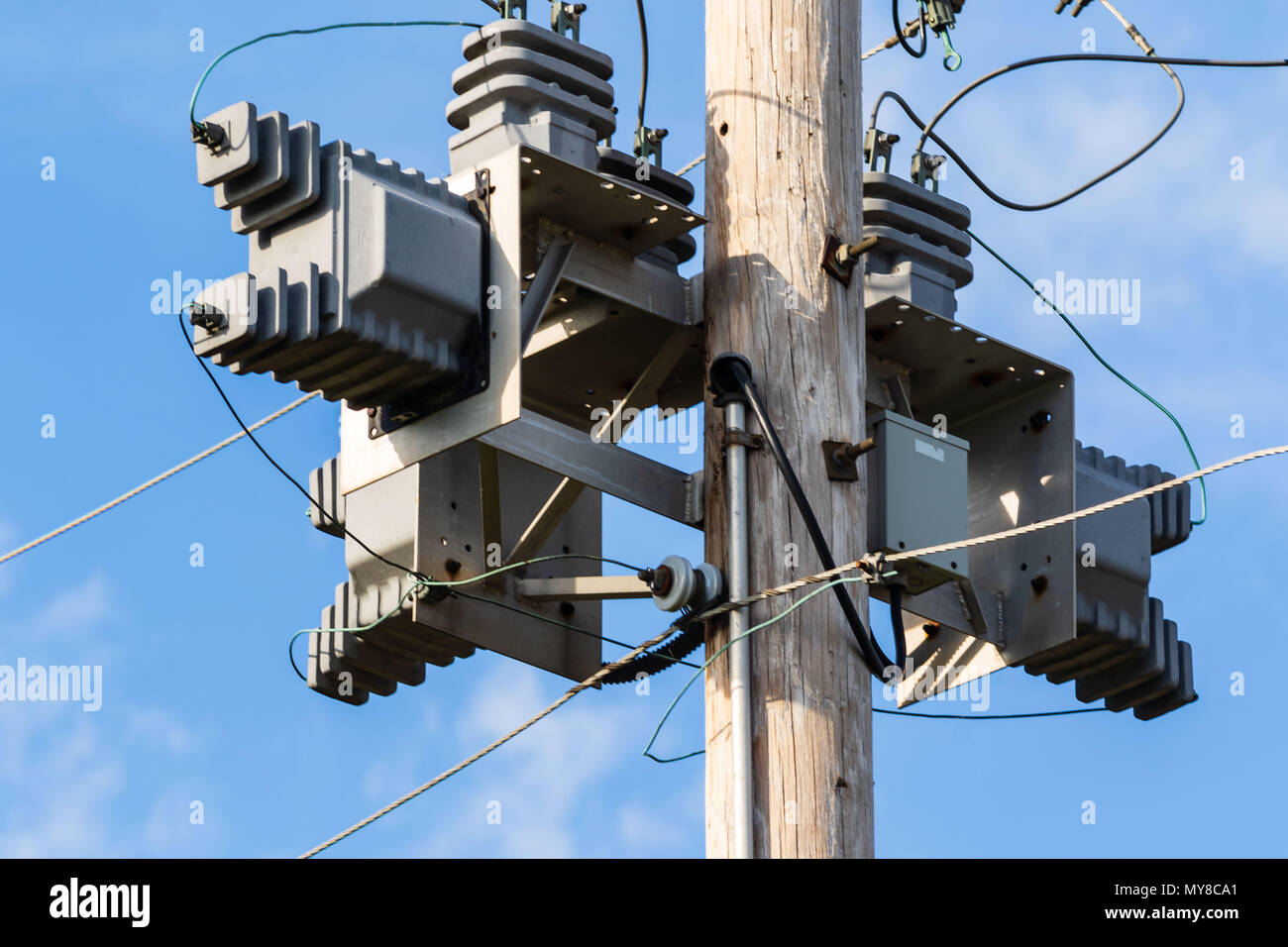 some electrical equipment high up on a pole one Stock Photo