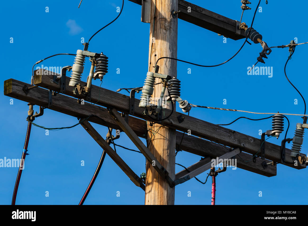 some electrical equipment high up on a pole three Stock Photo