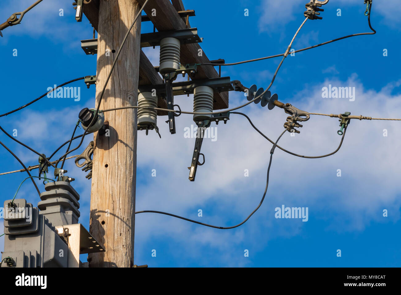 some electrical equipment high up on a pole four Stock Photo