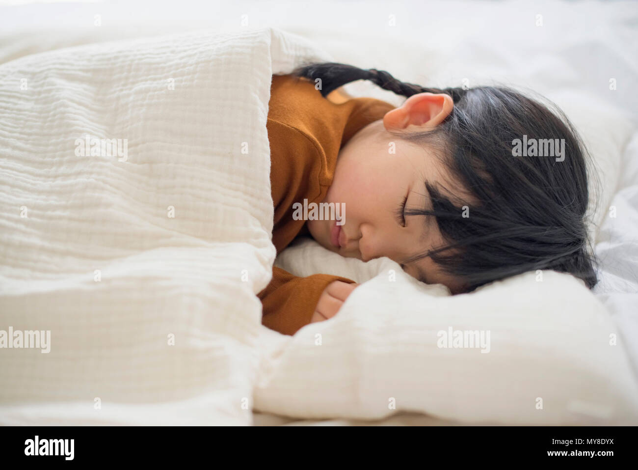 Little girl sleeping in bed Stock Photo - Alamy