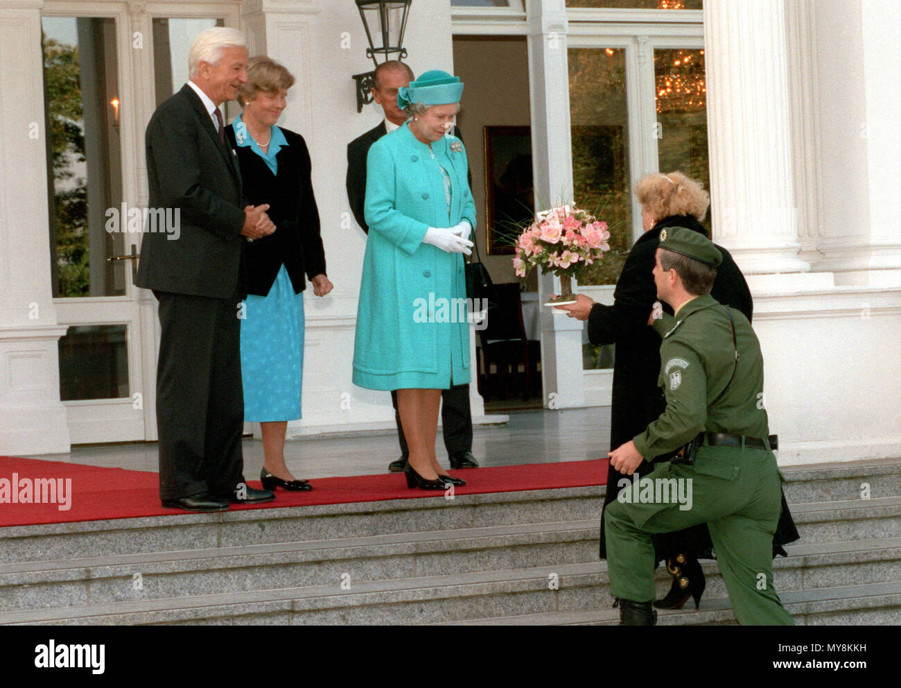 Irma Oettinger (r), an admirer of the Queen from Langenbrettbach near Heilbronn, accompanied by a member of the Federal Border Guard (BGS), hands a bunch of flowers to British Queen Elizabeth II on the terrace of Villa Hammerschmidt in Bonn, Germany, on 19 October 1992. Standing on the left are German President Richard von Weizsäcker and his wife Marianne, in the background is Prince Philip. | usage worldwide Stock Photo