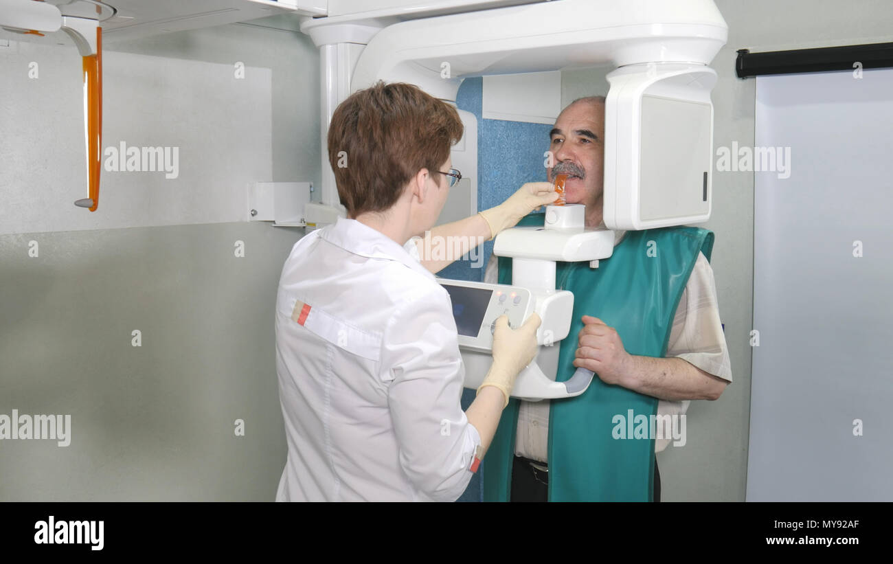 Senior patient examination of teeth by using panoramic and