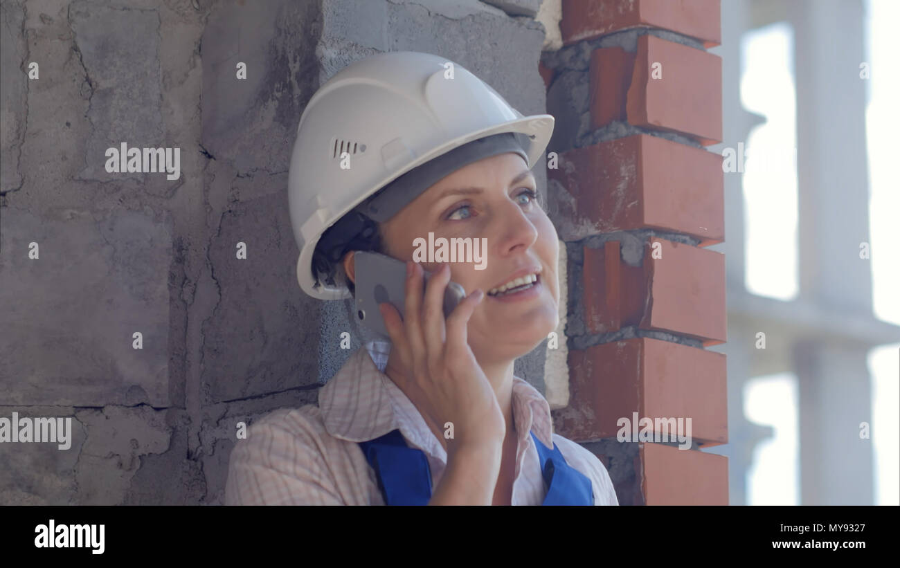 Confident female architect talking on phone Stock Photo