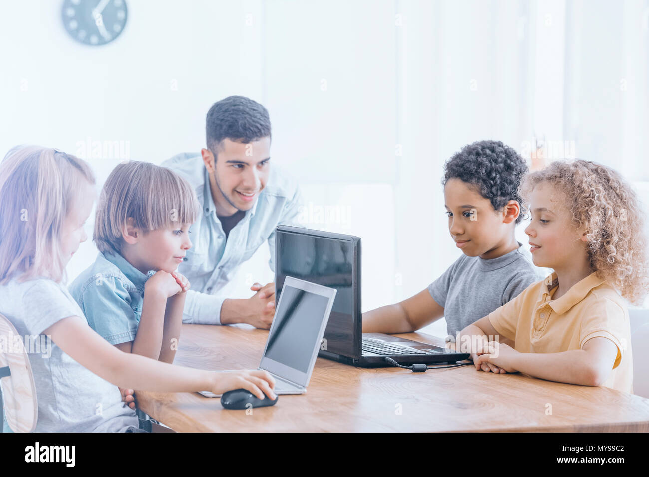 Happy children learn programming using laptops on extracurricular ...