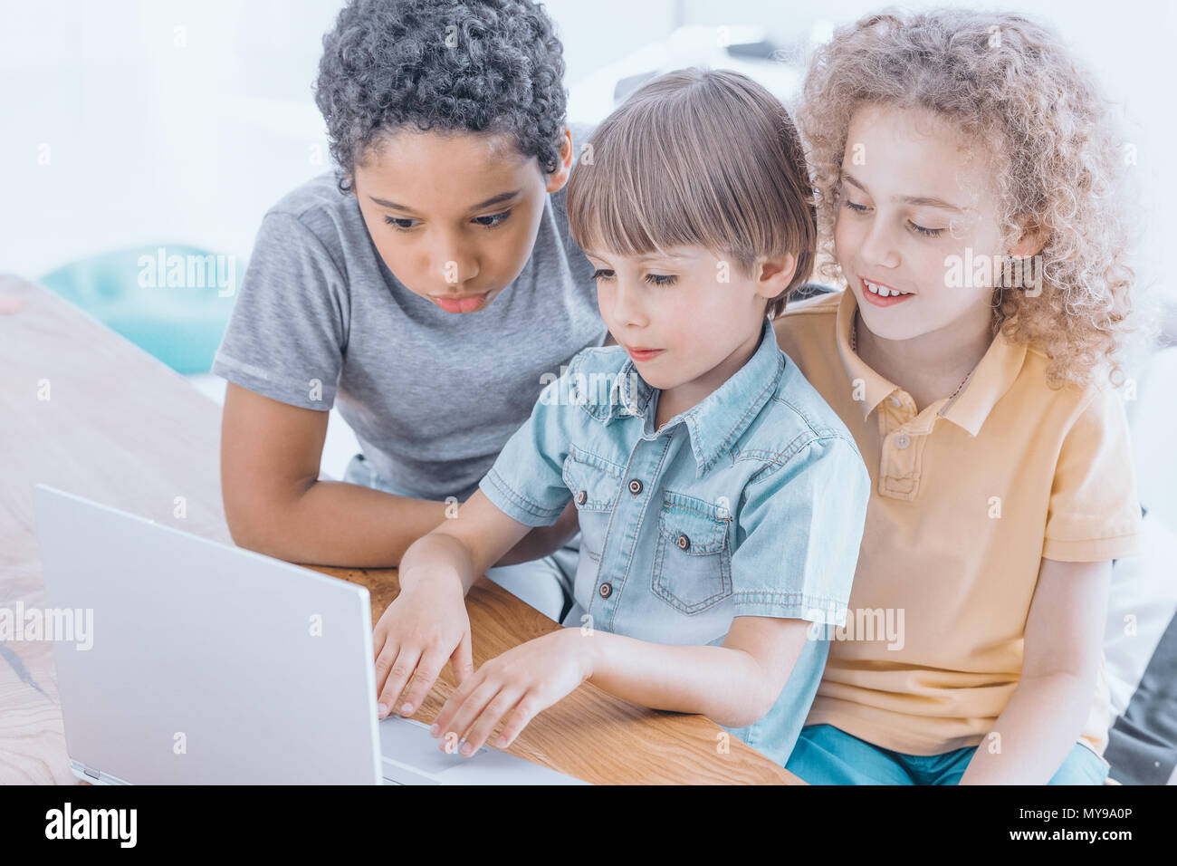 Older children help their younger colleagues during programming classes ...