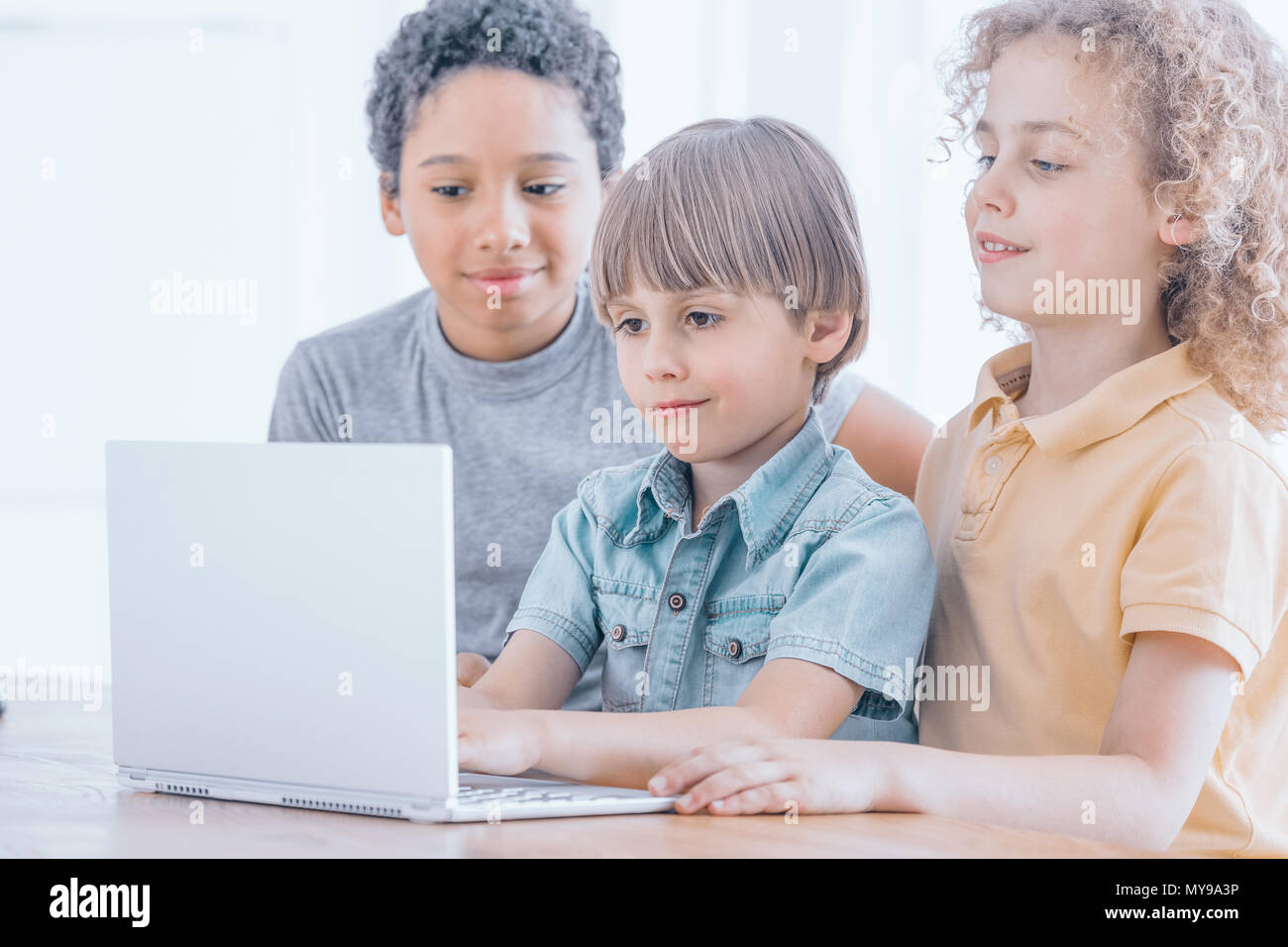 Young boy learns to program the robots during coding classes, children coding concept Stock Photo