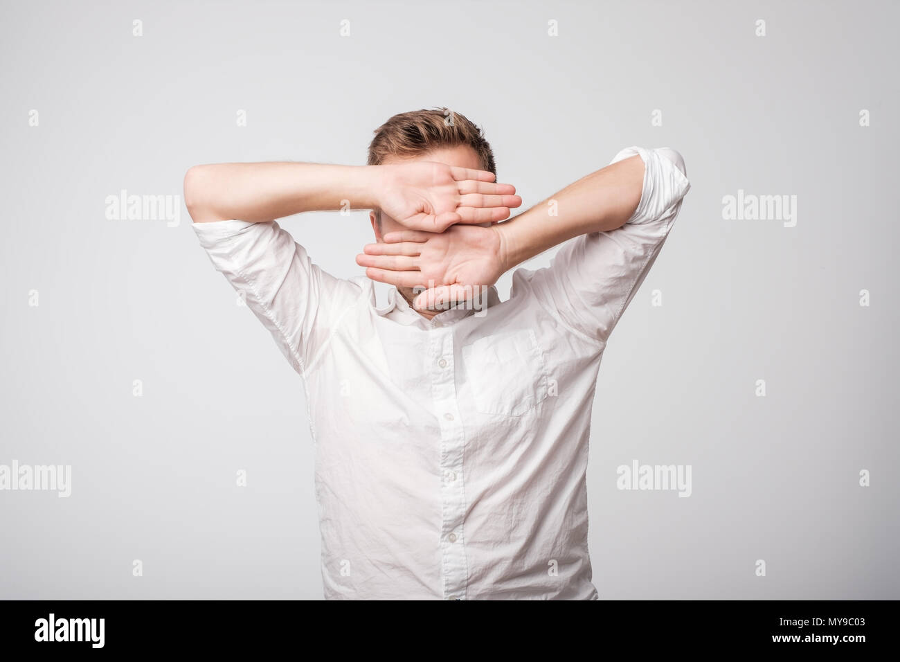 Portrait of desperate sad caucasian man hiding his face Stock Photo