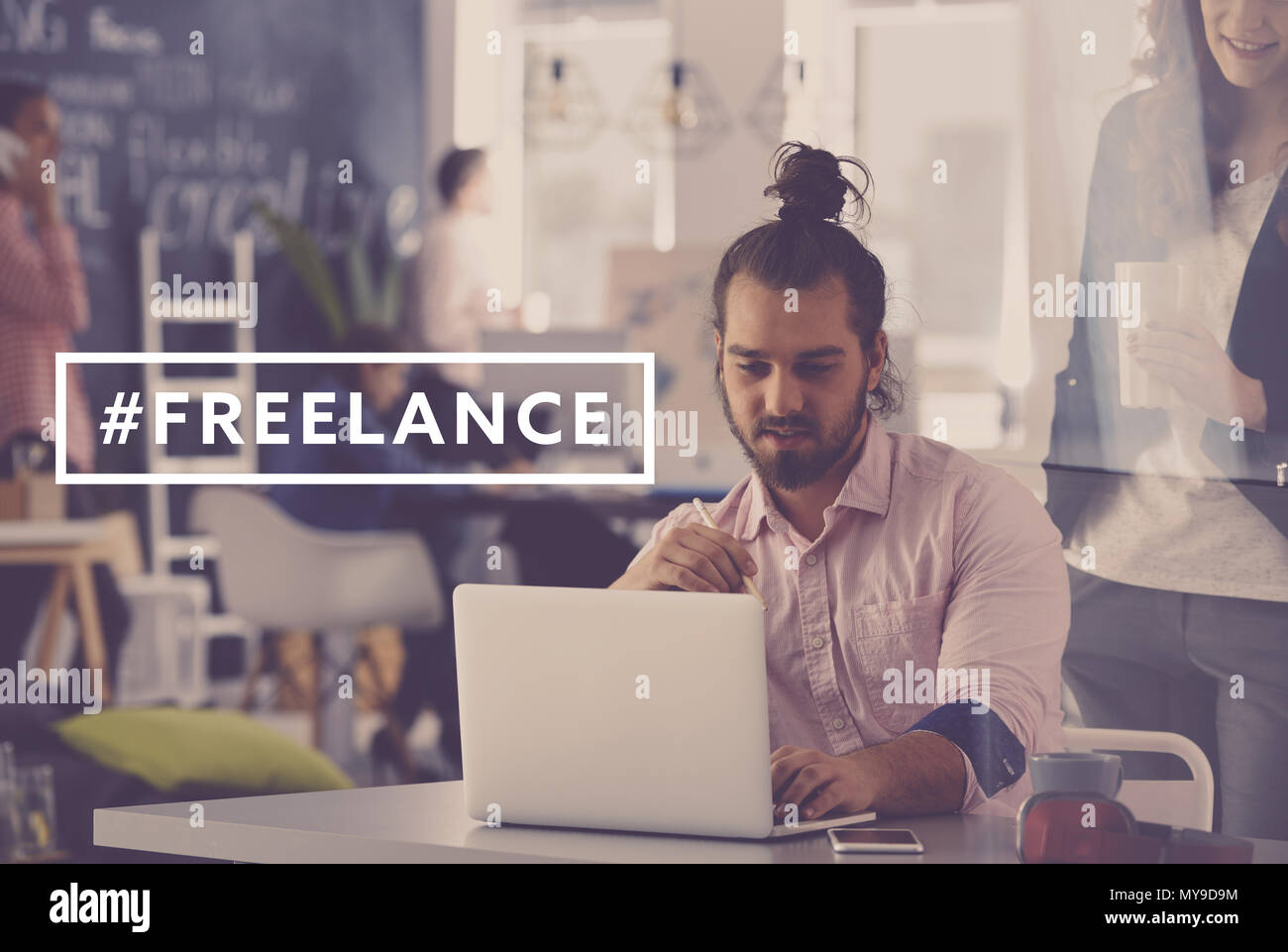 Young and creative freelance worker using laptop at work Stock Photo