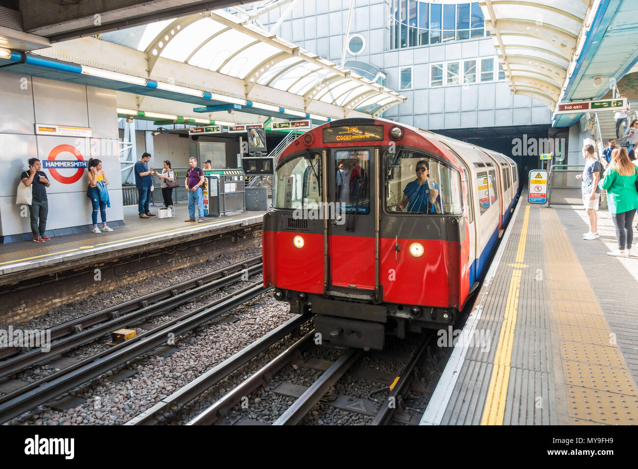 A train arrives into the platform at Hammersmith London Underground Station. Stock Photo