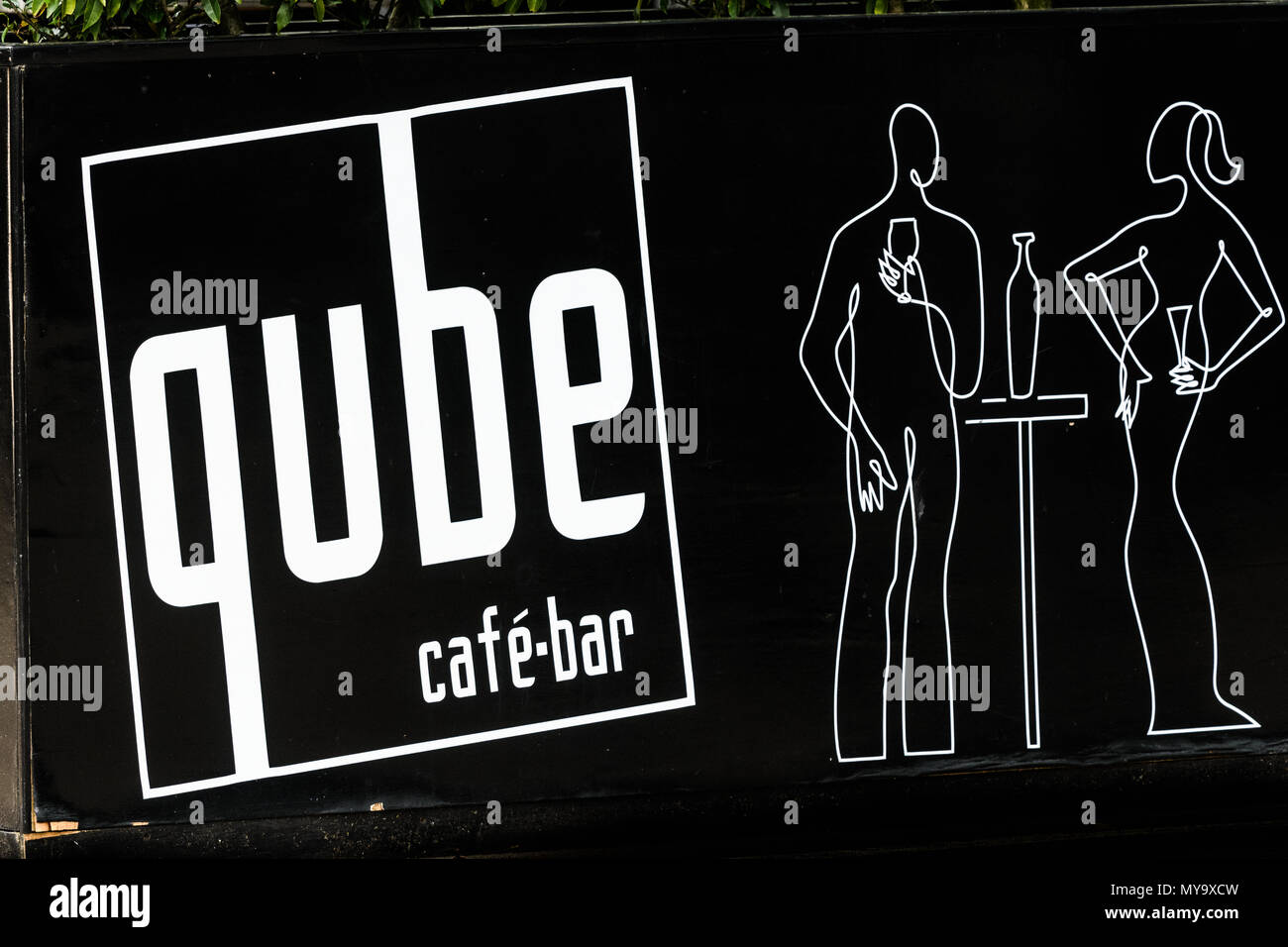 Black and white sign on the Qube cafe bar in the town center of Corby, Northamptonshire, England. Stock Photo
