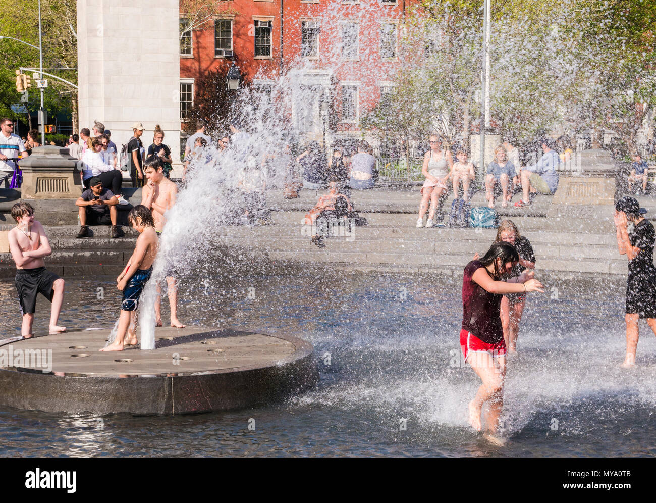 Boys and girls playing, and cooling down in fountain, Washington Square, New York City, USA Stock Photo