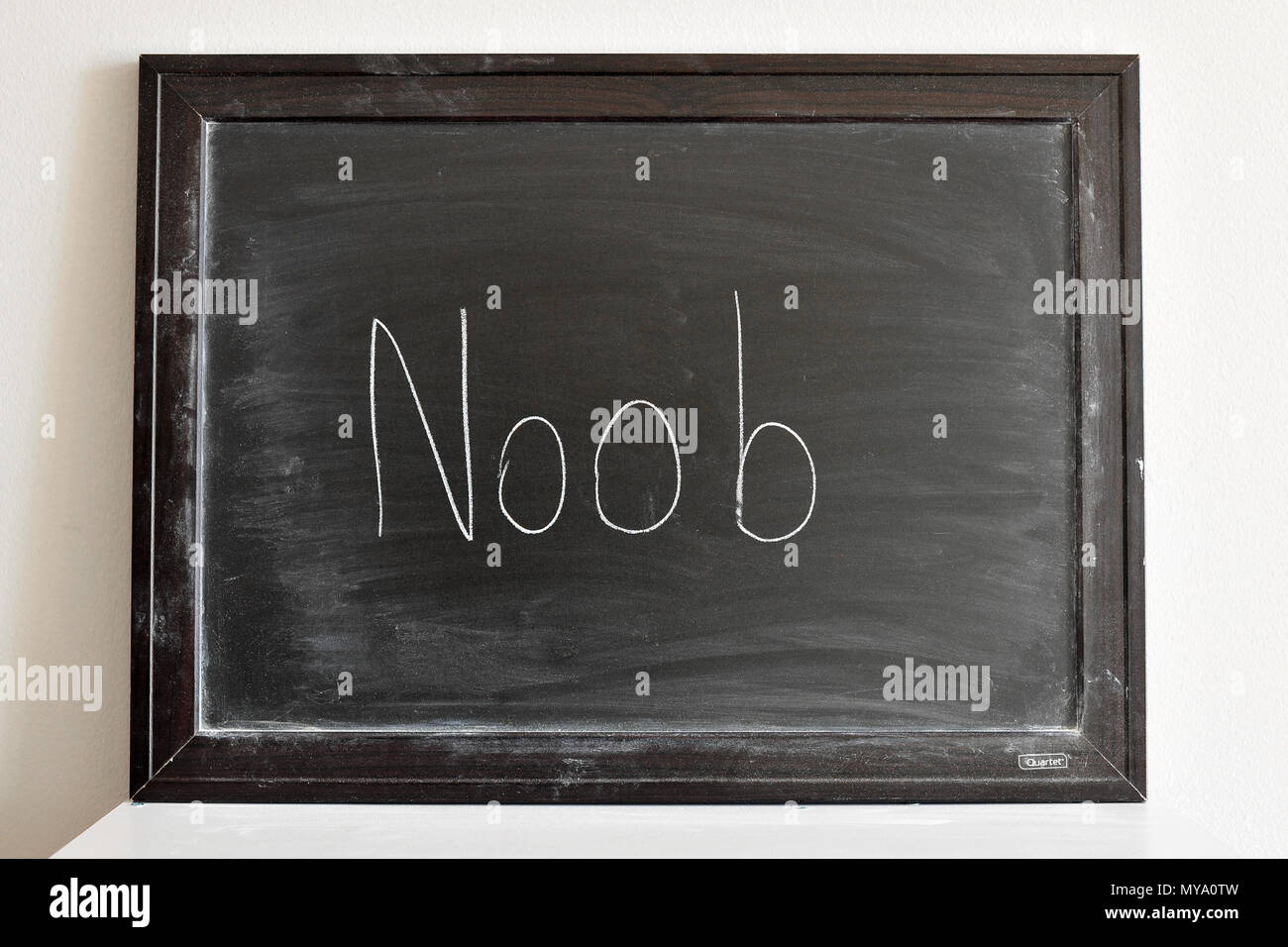 Noob written in white chalk on a blackboard Stock Photo
