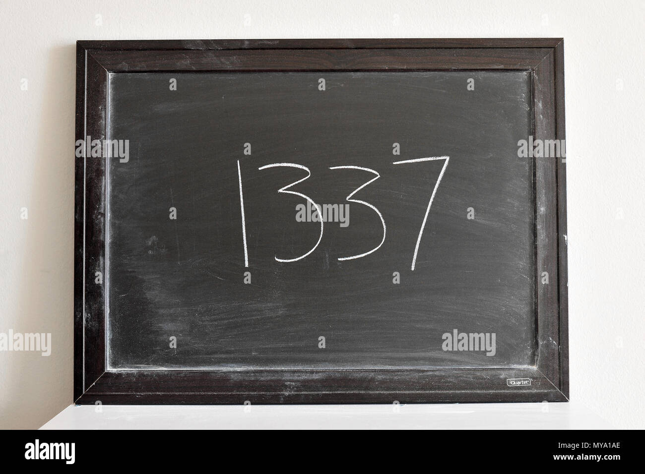 1337 written in white chalk on a blackboard Stock Photo