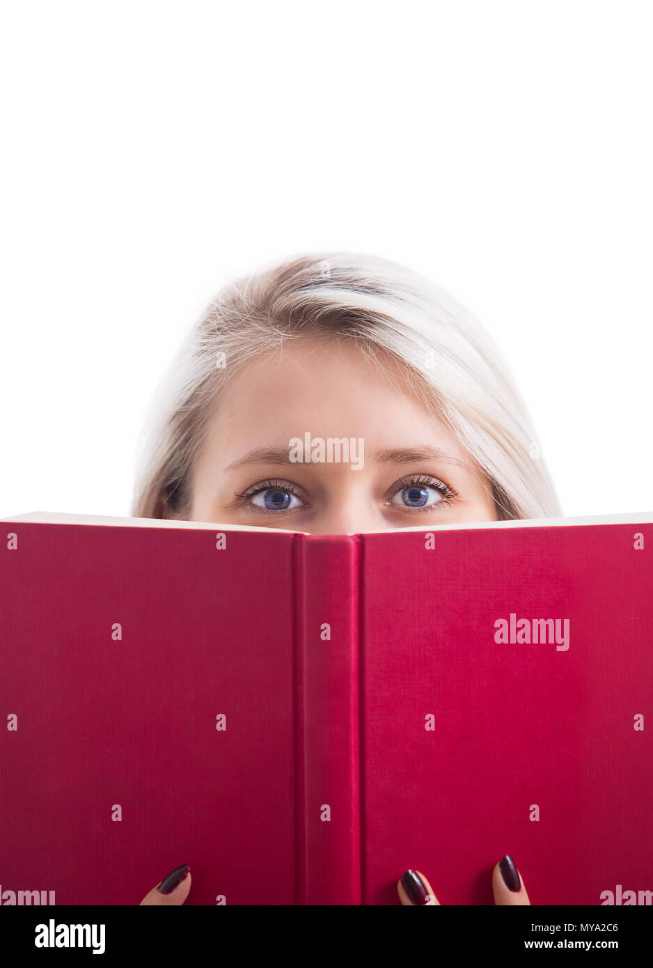 Close up portrait of pretty student girl hiding behind a red opened book isolated on white background. Mysterious and shy woman keeping a secret. Educ Stock Photo