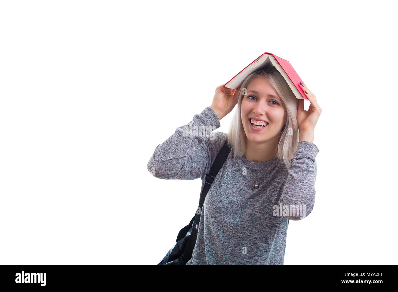 Pretty smiling woman holding a opened book over her head isolated on ...