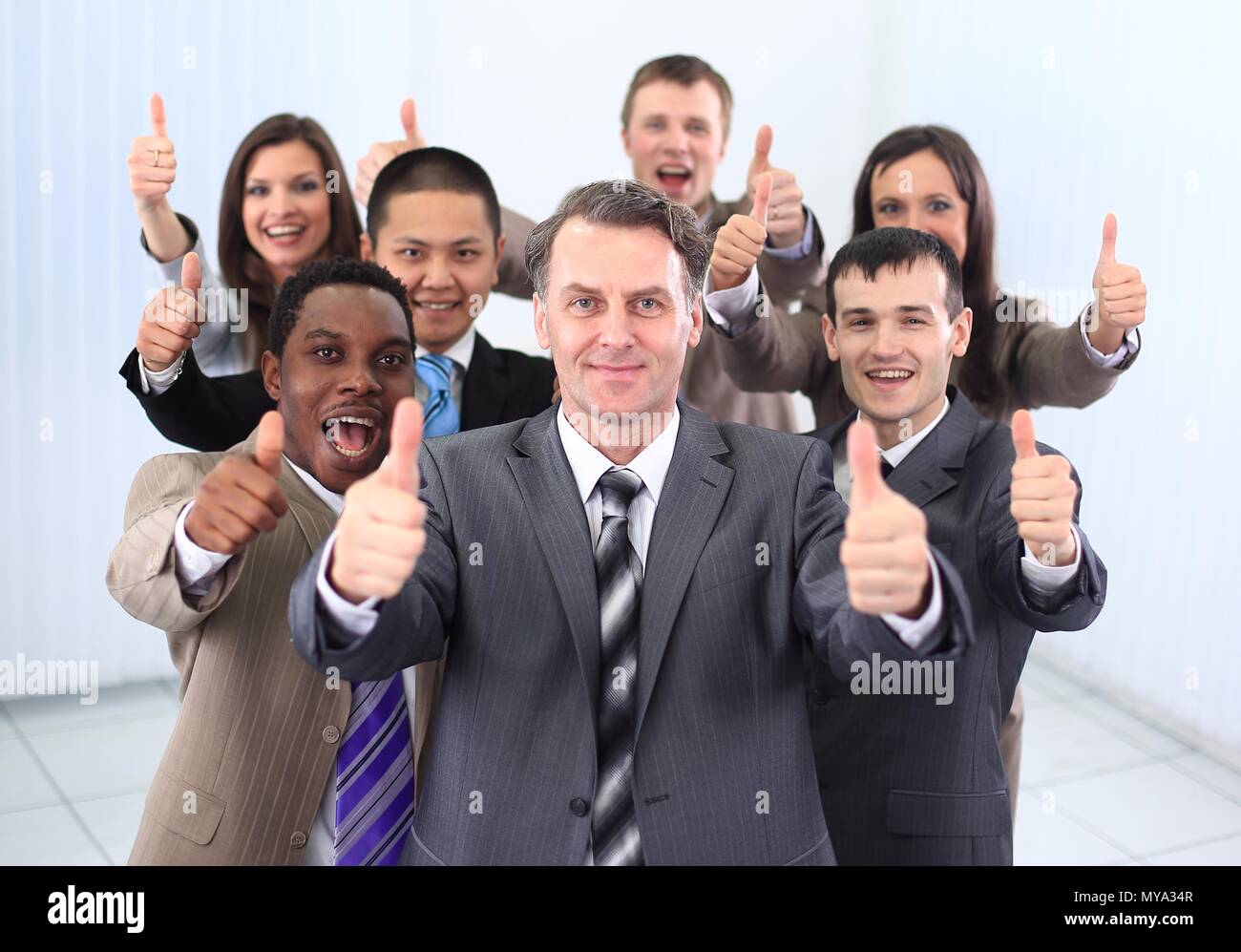 happy business team holding thumbs up Stock Photo - Alamy