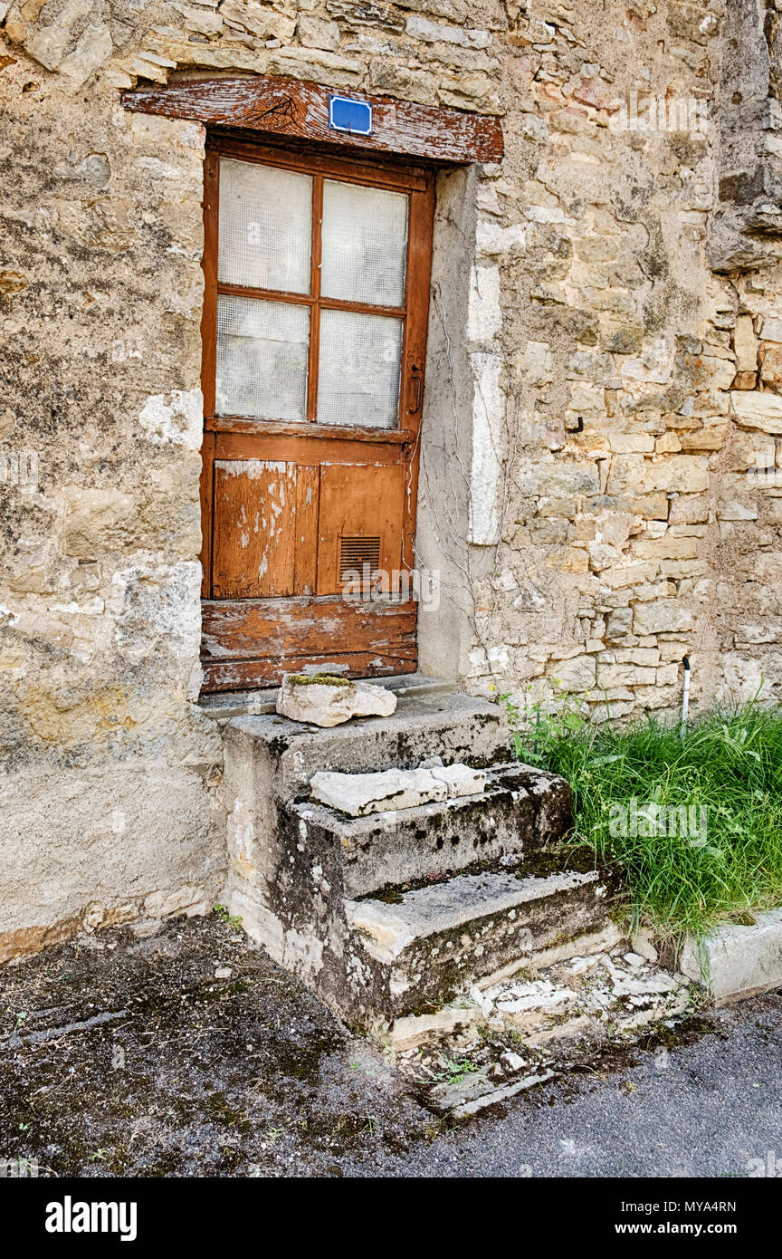 Four steps leads to a small door in the village of Santenay in the Burgundy region of France. Stock Photo