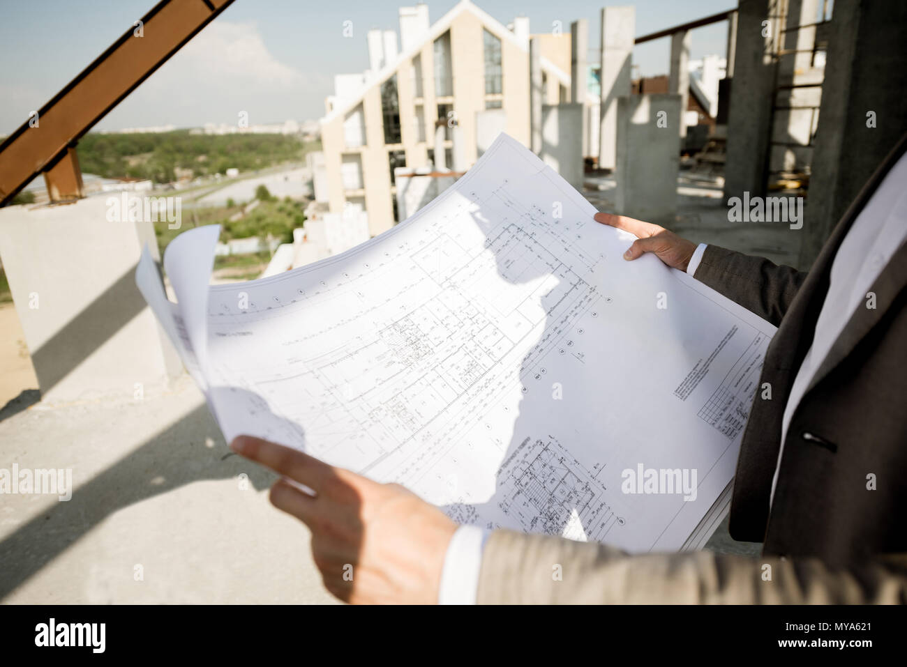 Holding house plan drawings on the structure Stock Photo