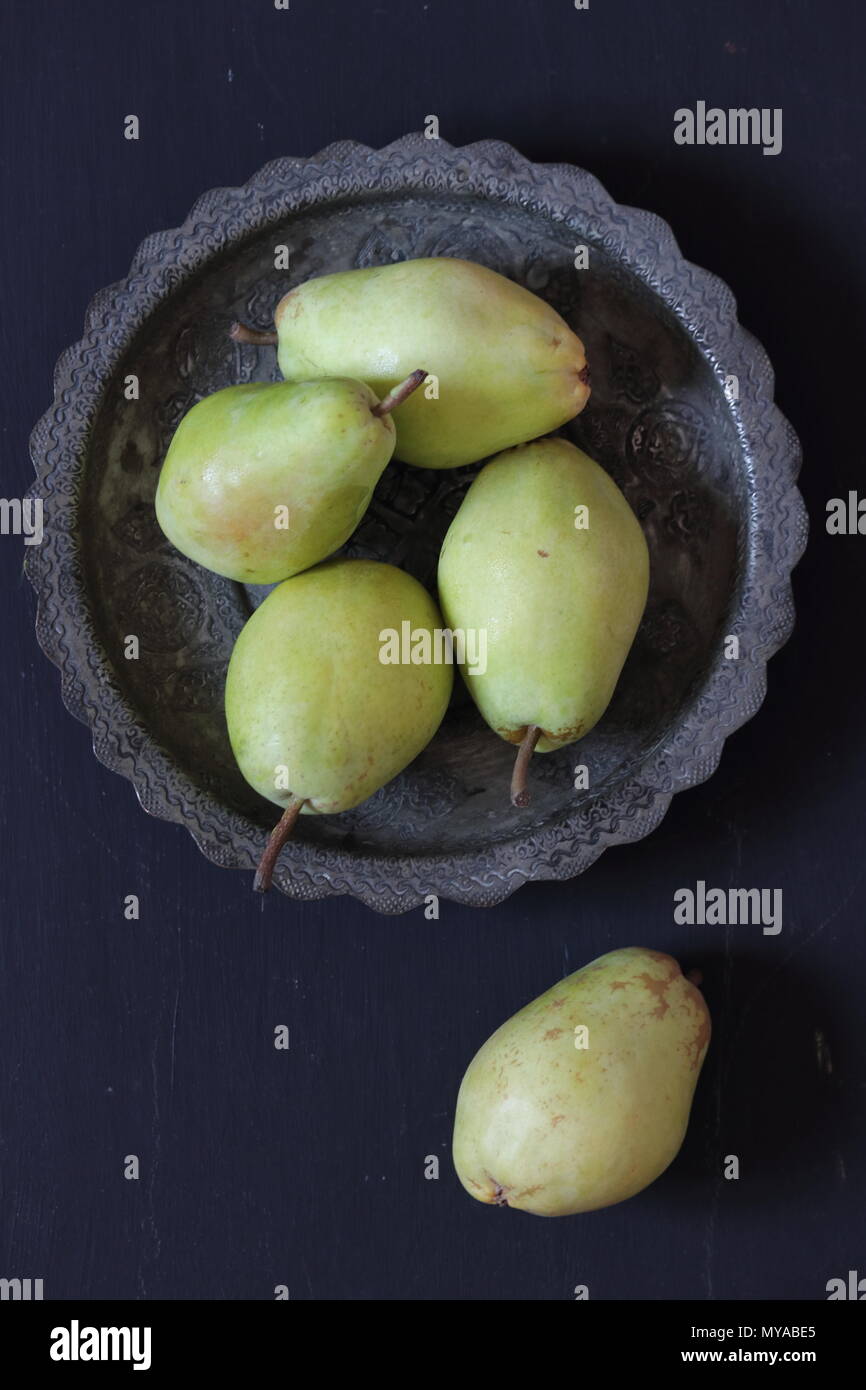Pears in a plate on a black background Stock Photo