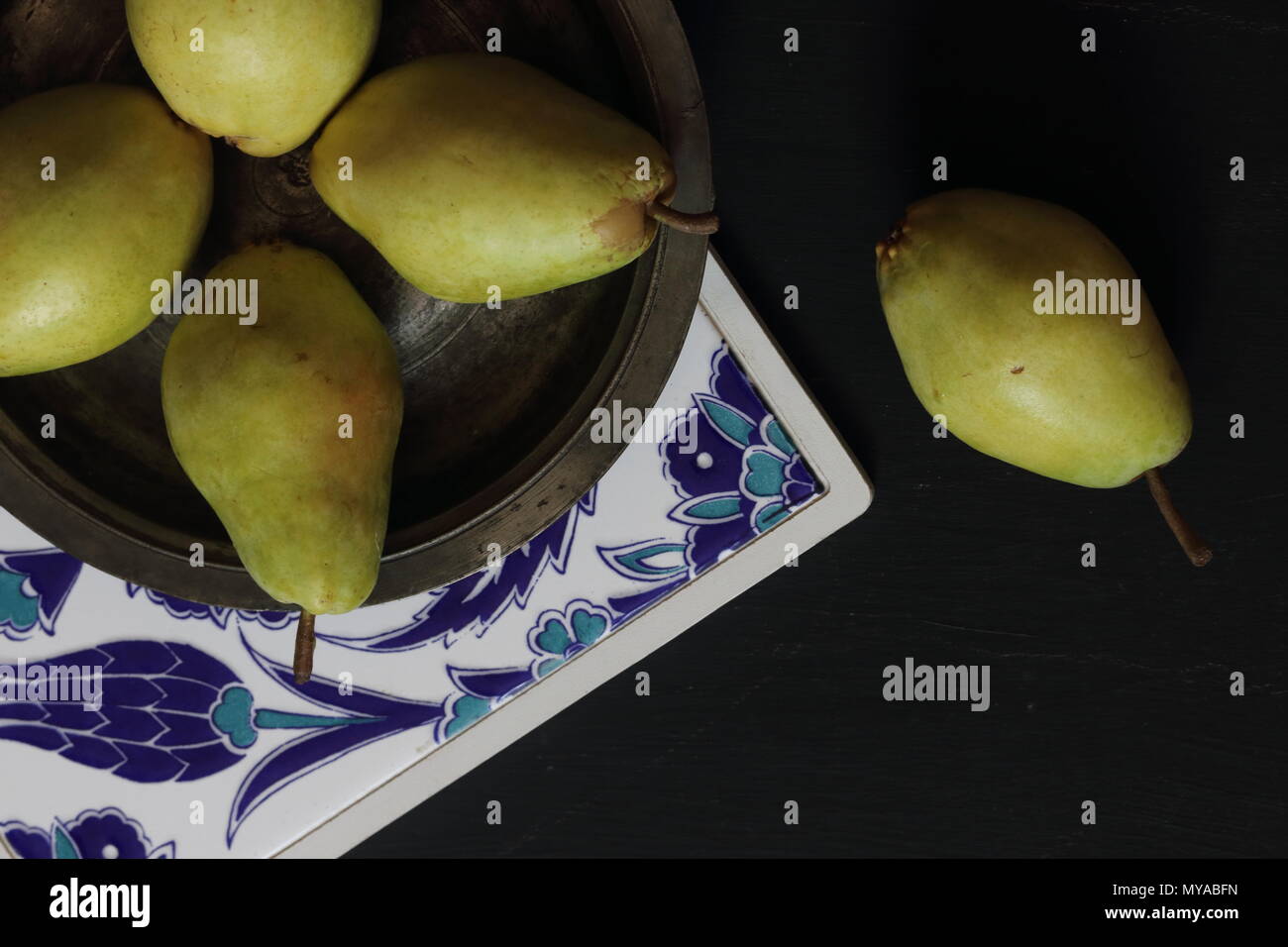 Pears in a plate on a black background Stock Photo
