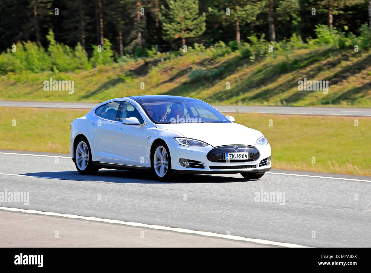 White Tesla Model S Electric Car At Speed On Motorway In The