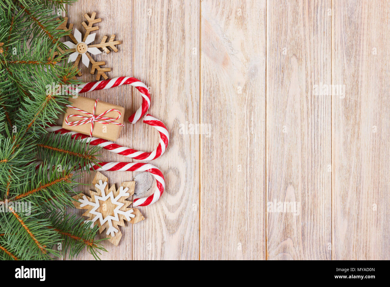 Christmas gift box, candy cane with snowflake and fir tree branch on ...