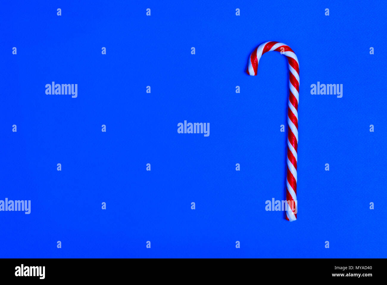 Christmas candy cane on blue background. Flat lay and top view. copy space Stock Photo Alamy