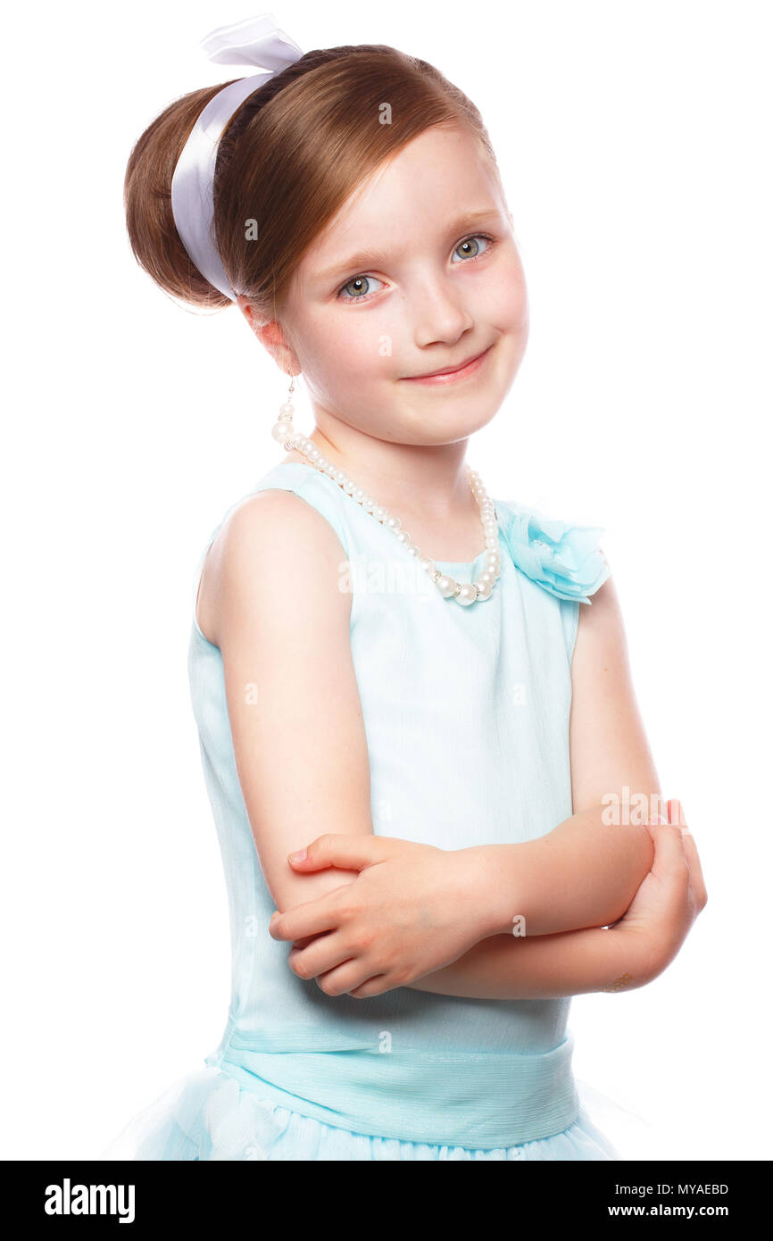A little girl in a blue dress, with a retro hairstyle and accessories