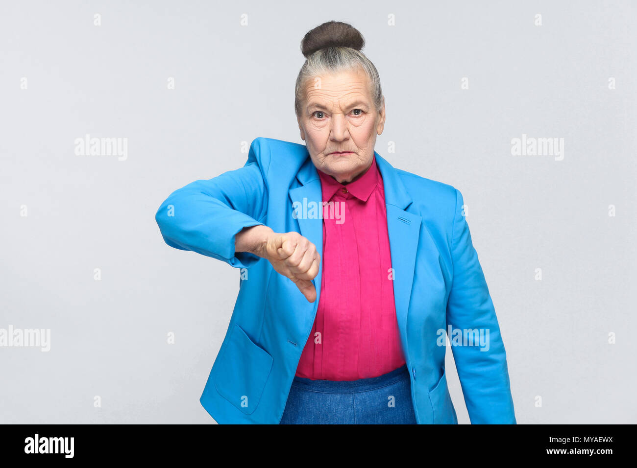 Unhappy woman showing dislike sign 