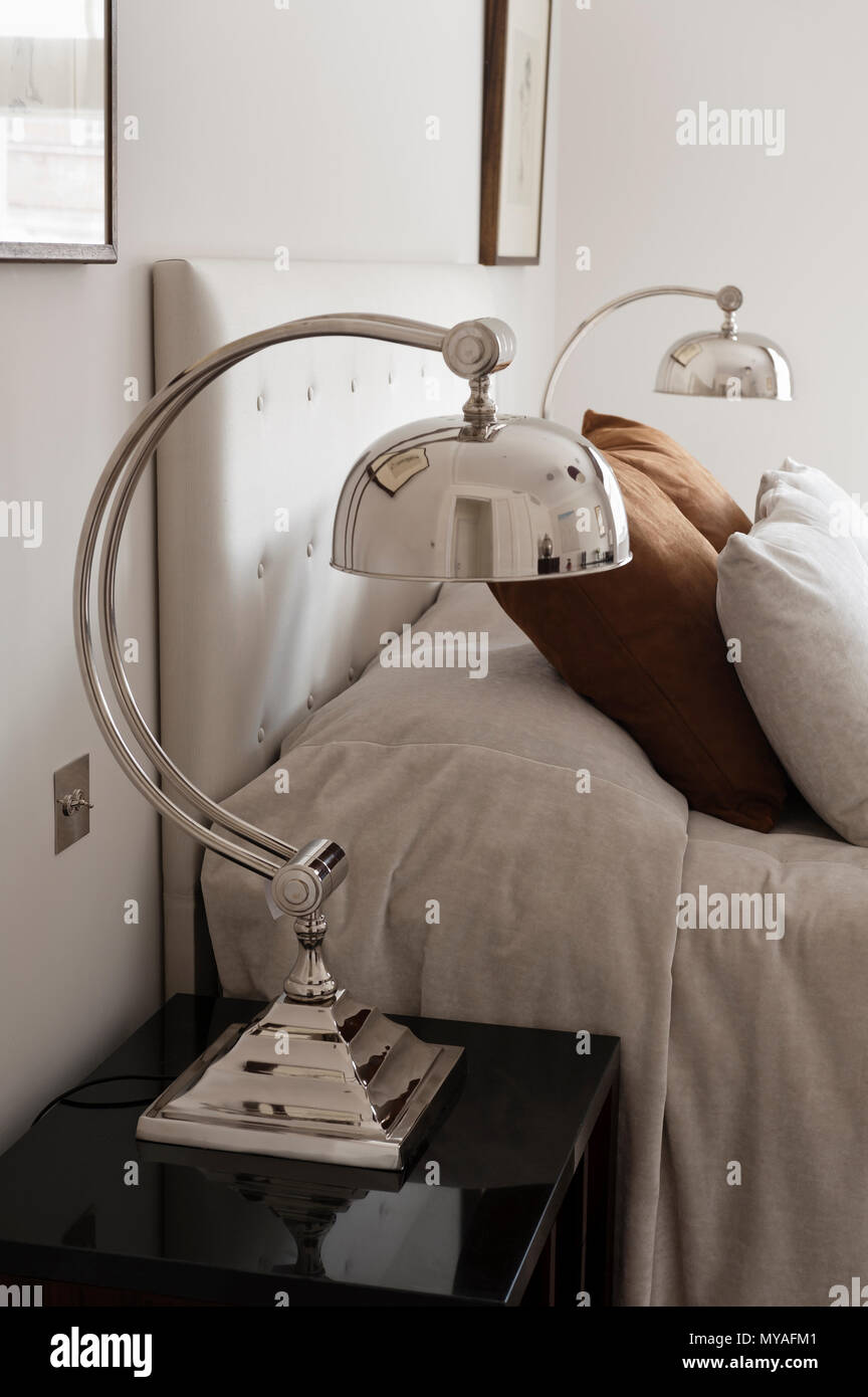 Matching lamps beside double bed Stock Photo Alamy