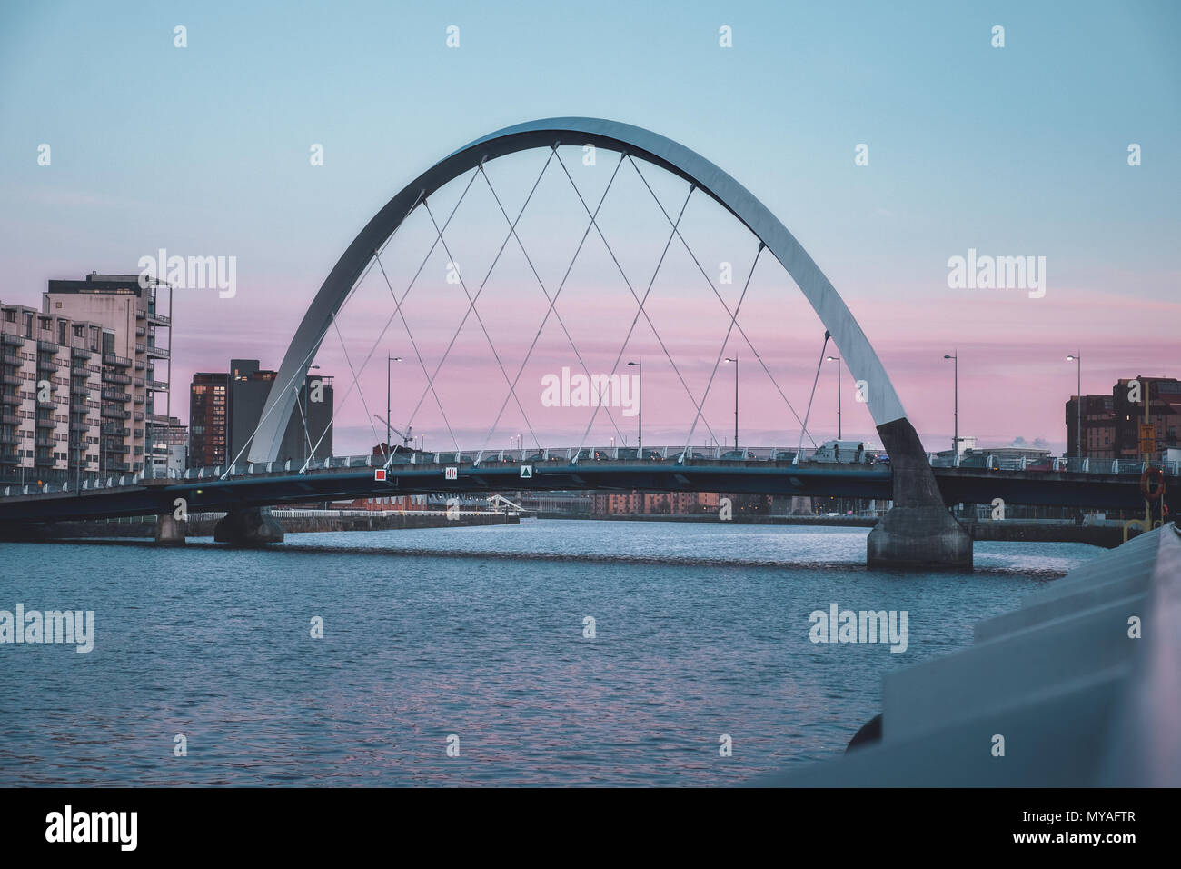 View of the Clyde Arc or Squinty Bridge from the East at sunset and river Clyde, Glasgow, Scotland Stock Photo