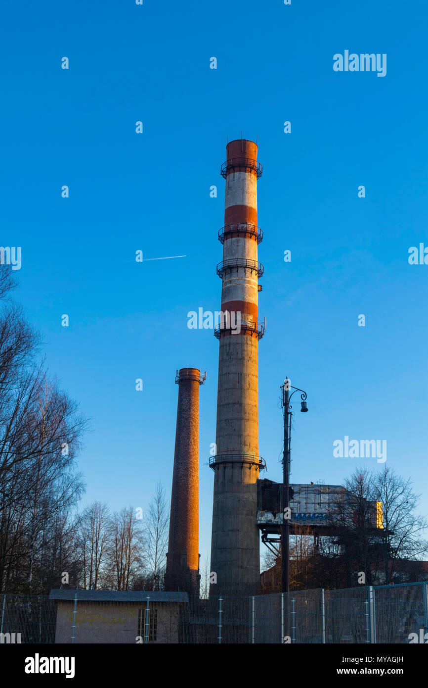 Industrial smokestack on sunny day with blue sky and copy space