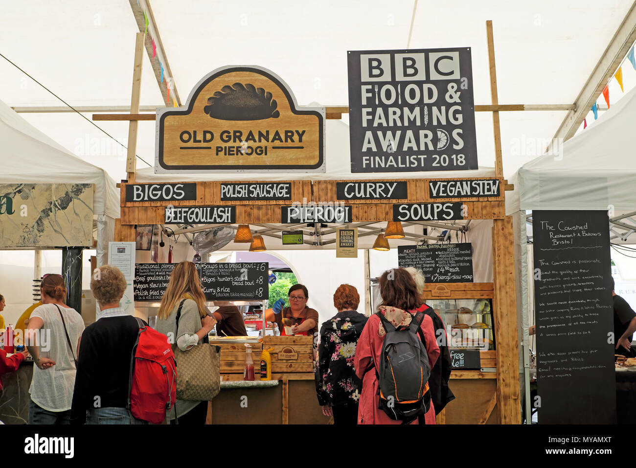 People buying food outside the Old Granary stall & BBC Food & Farming Awards sign at Hay Festival Food Hall marquee  Hay-on-Wye Wales UK  KATHY DEWITT Stock Photo