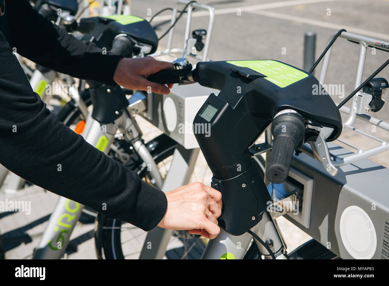 Portugal, Lisbon 29 april 2018: city bicycles or alternative ecological public transport and lease of city bicycle. A person takes a bicycle for rent Stock Photo