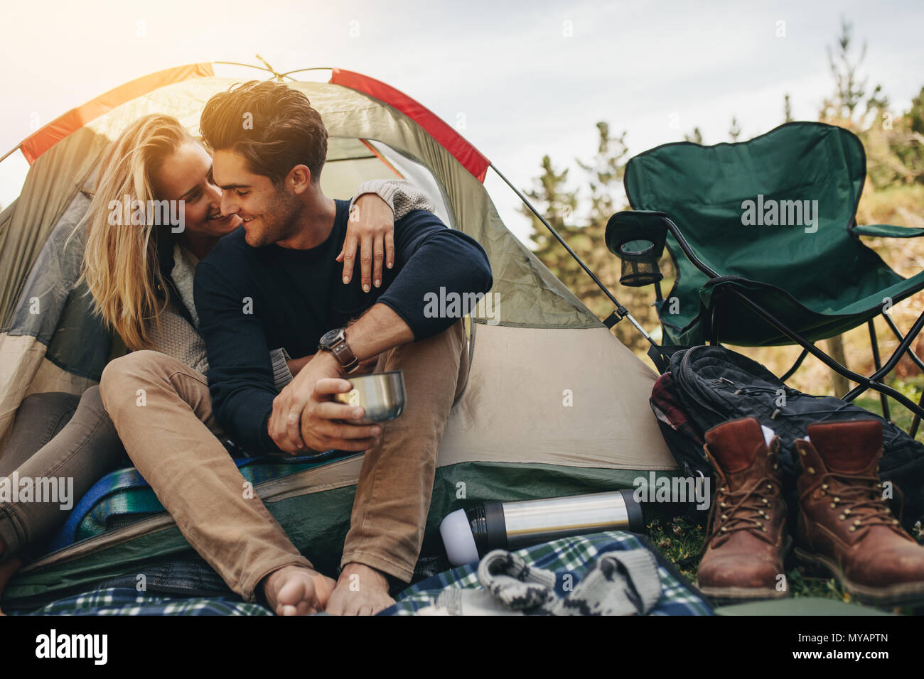 Romantic Couple Camping Outdoors And Sitting In A Tent Happy Man And Woman On A Romantic Camping Vacation Stock Photo Alamy