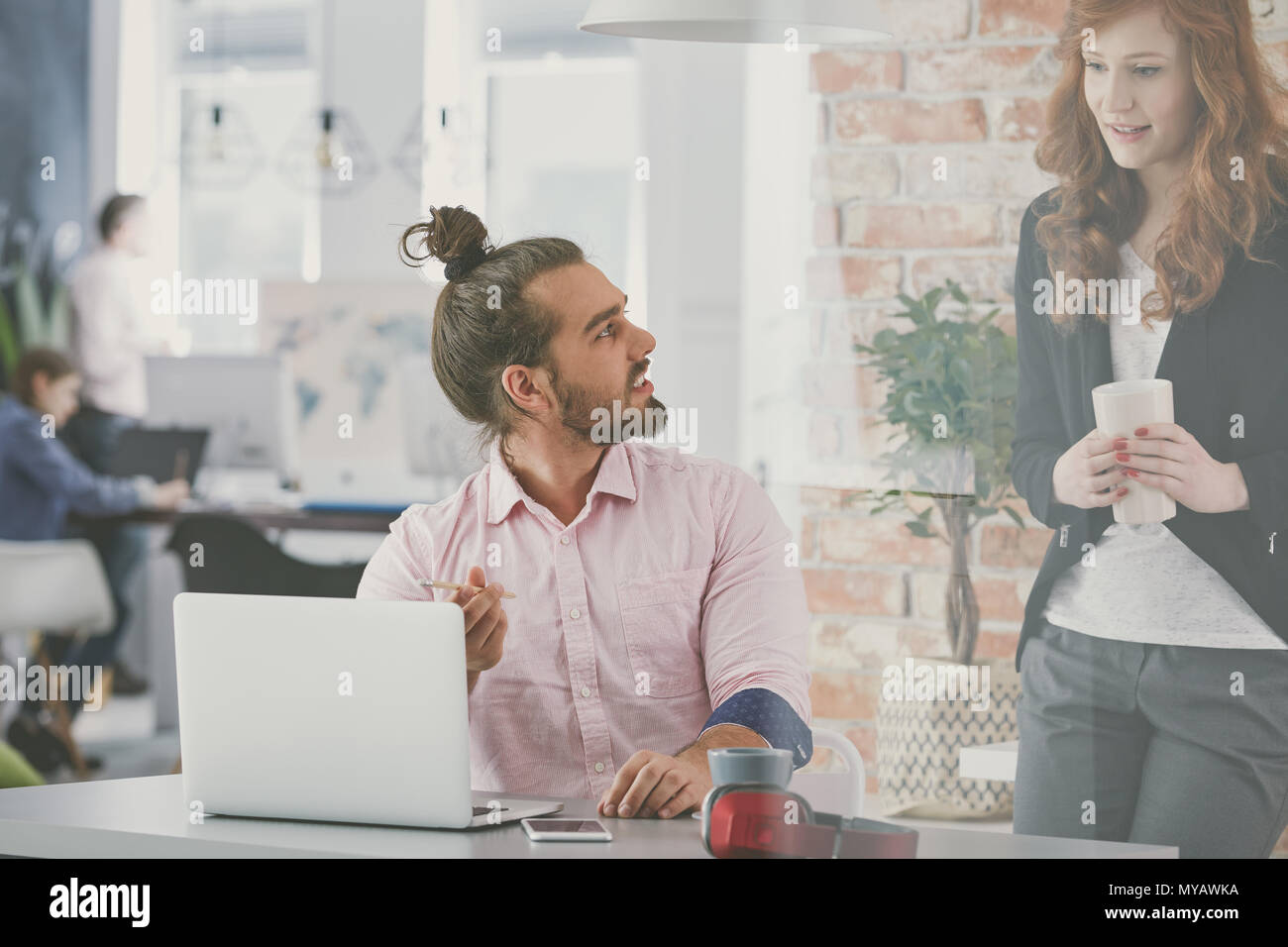 Young and creative business couple working in agency Stock Photo