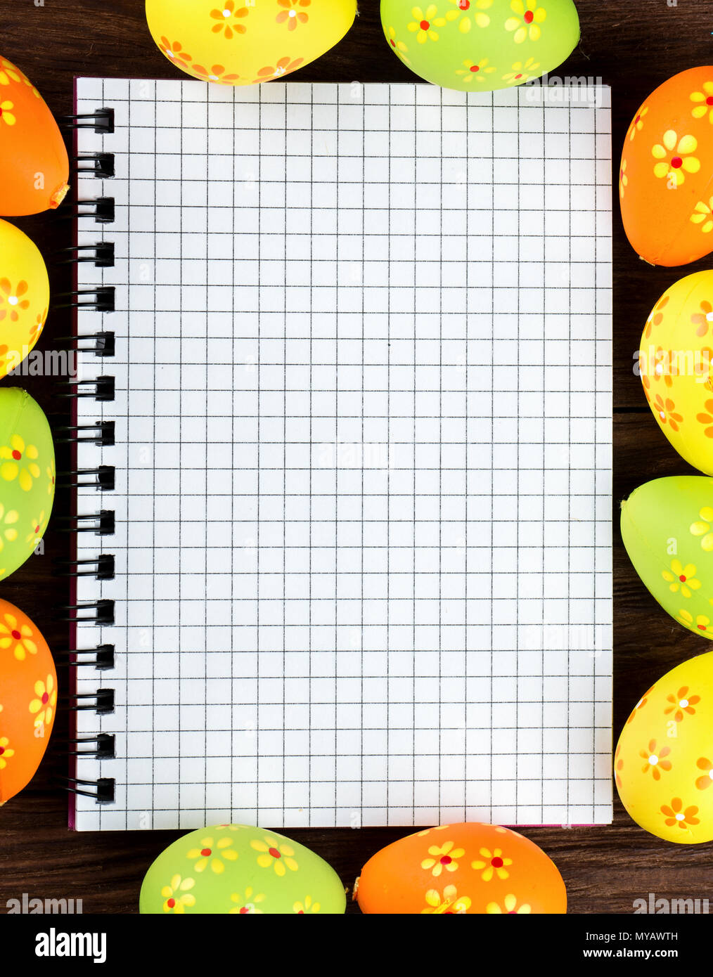 Blank notebook surrounded by Easter eggs for congratulations Stock Photo