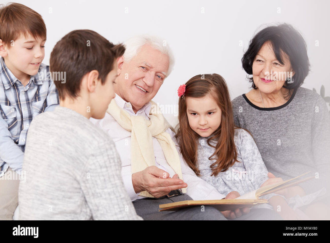 Happy family watching an old photo album Stock Photo - Alamy