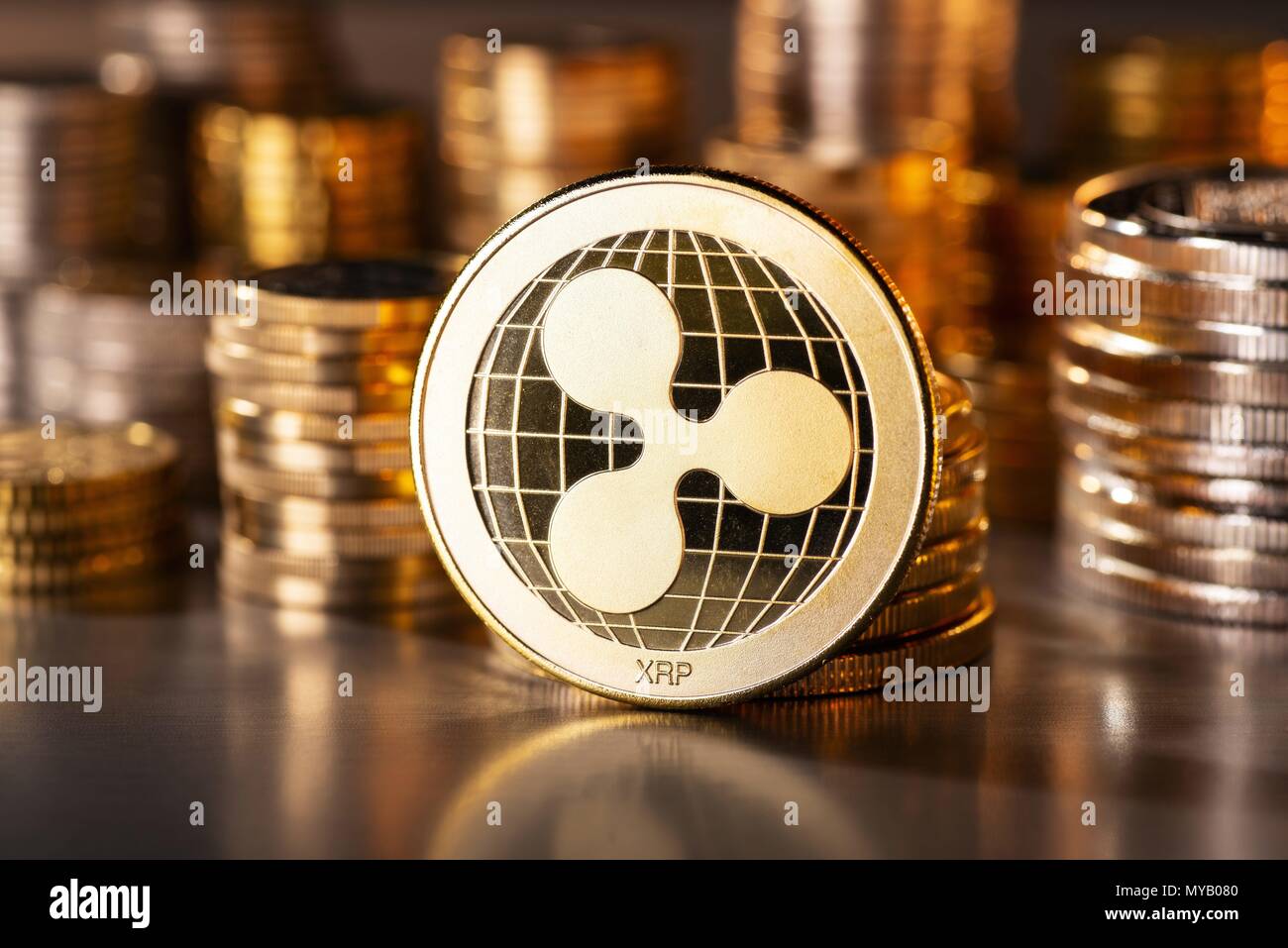 Crypto currency coin ripple with several stacks of coins in the background | usage worldwide Stock Photo