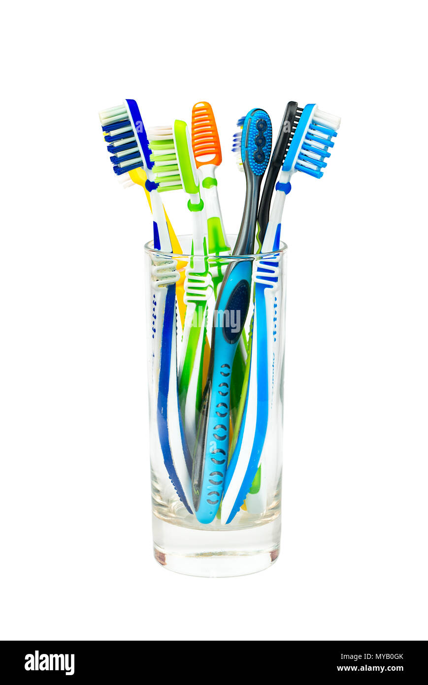 Many toothbrushes in a glass isolated on white background Stock Photo ...