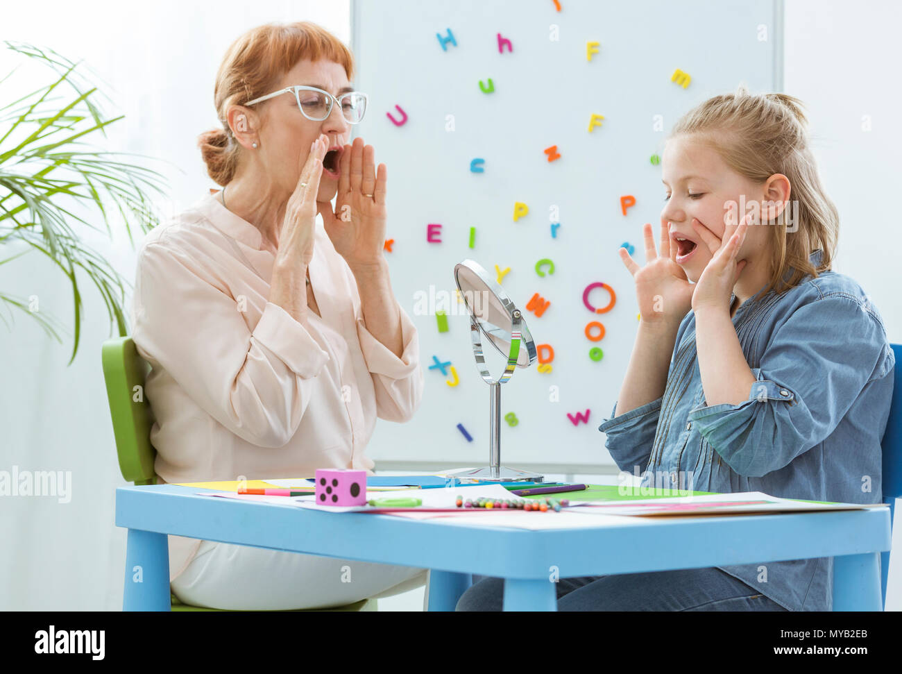 Female school counselor during extra-curricular classes with child Stock Photo