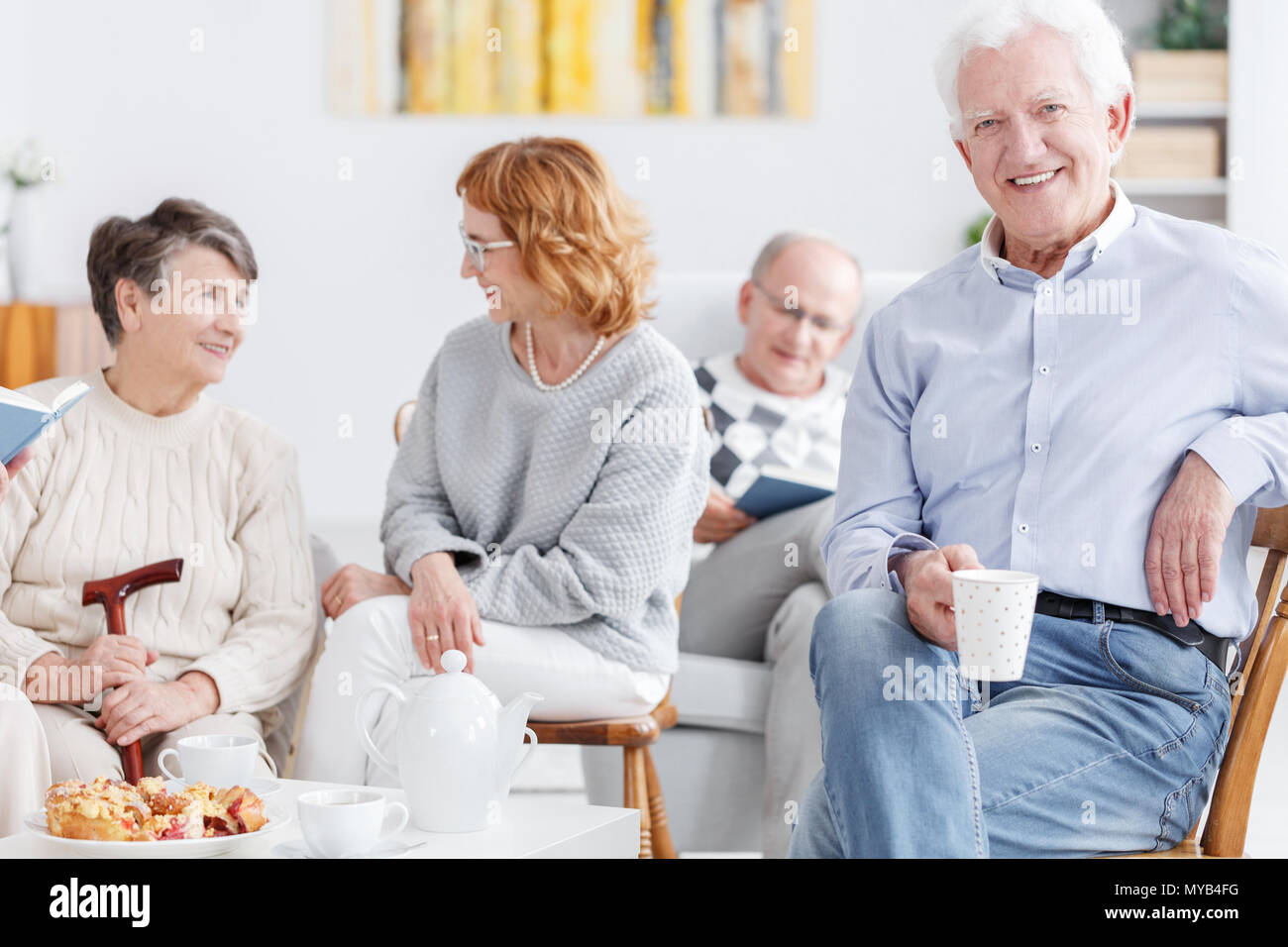 Elderly people drinking coffee in the afternoon in nursing home Stock