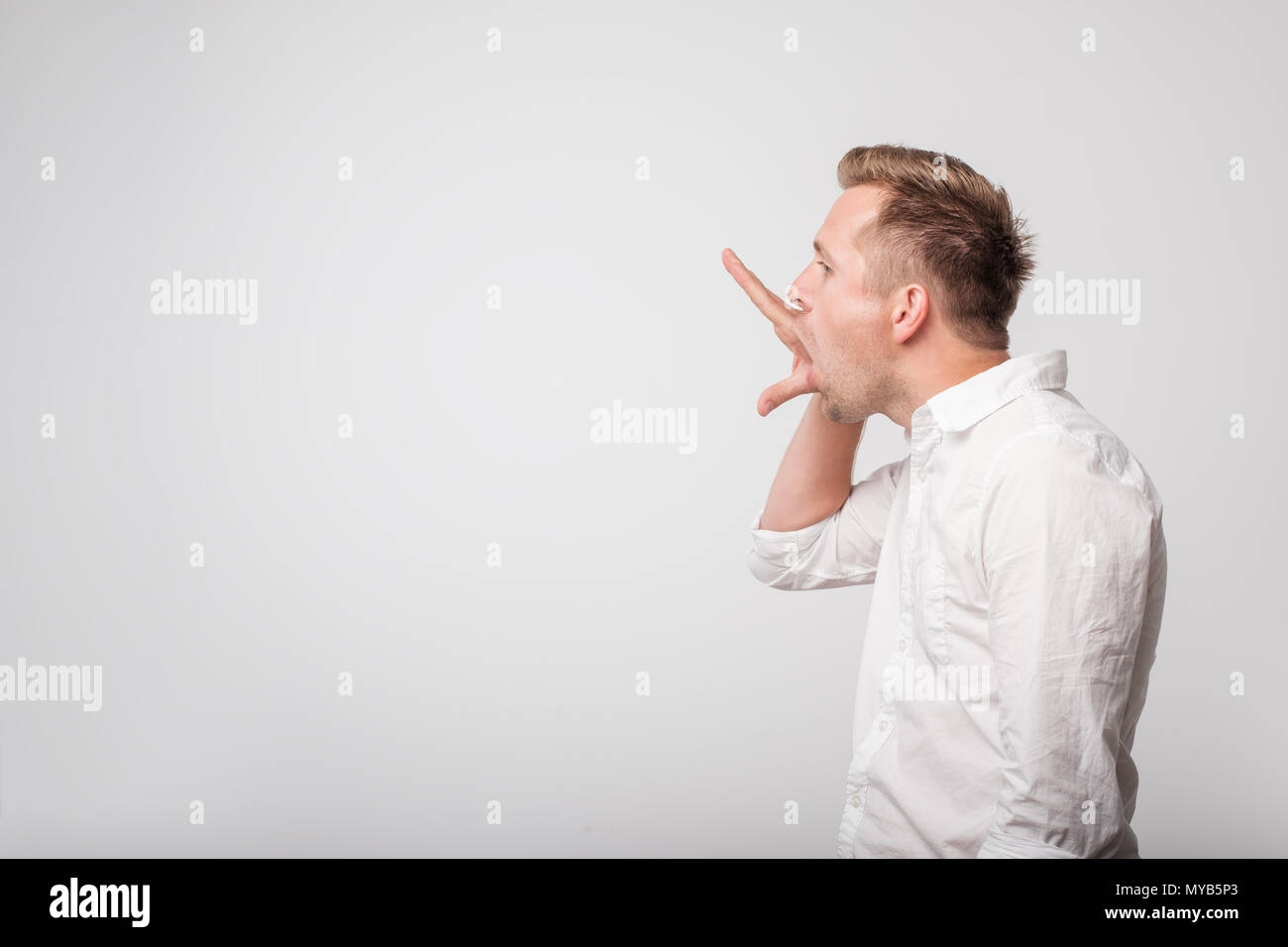 Caucasian man making bla bla sign with his hand. Empty promises. Stock Photo