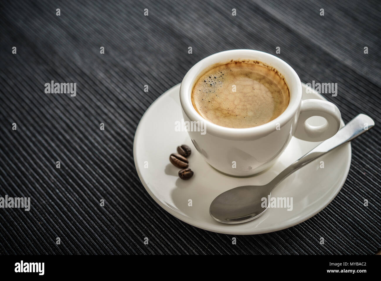 Coffee Espresso. Cup Of Coffee on textile  background closeup. Stock Photo