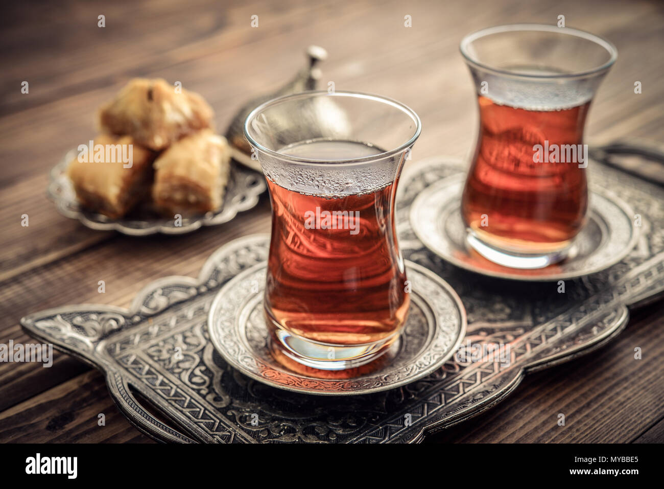 Cup of turkish tea served in traditional style with turkish delight on wooden background Stock Photo