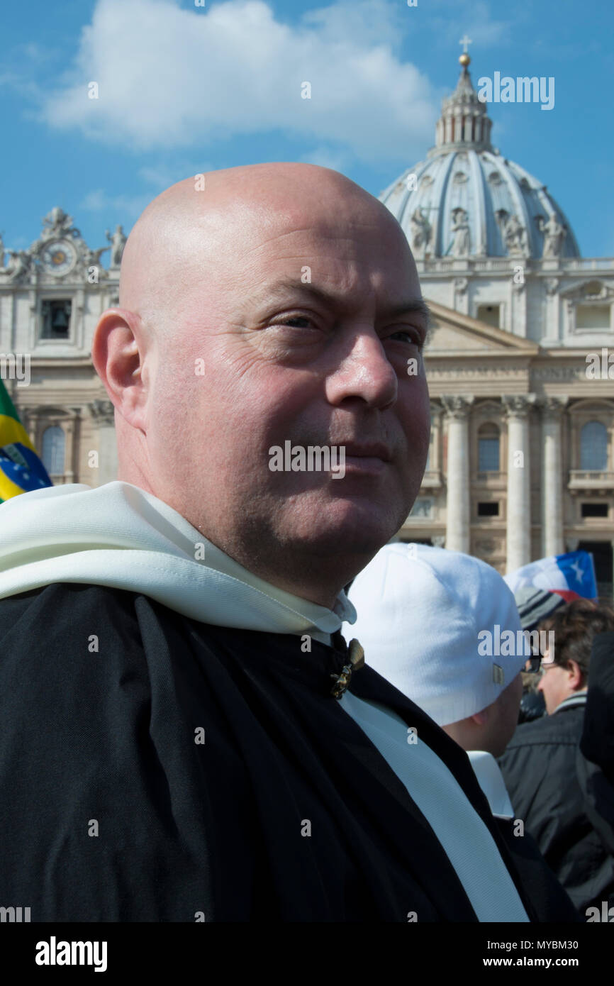 Vatican City State, 2013. Pilgrim waits in crowd for final Angelus Prayer of Pope Benedict XV Stock Photo
