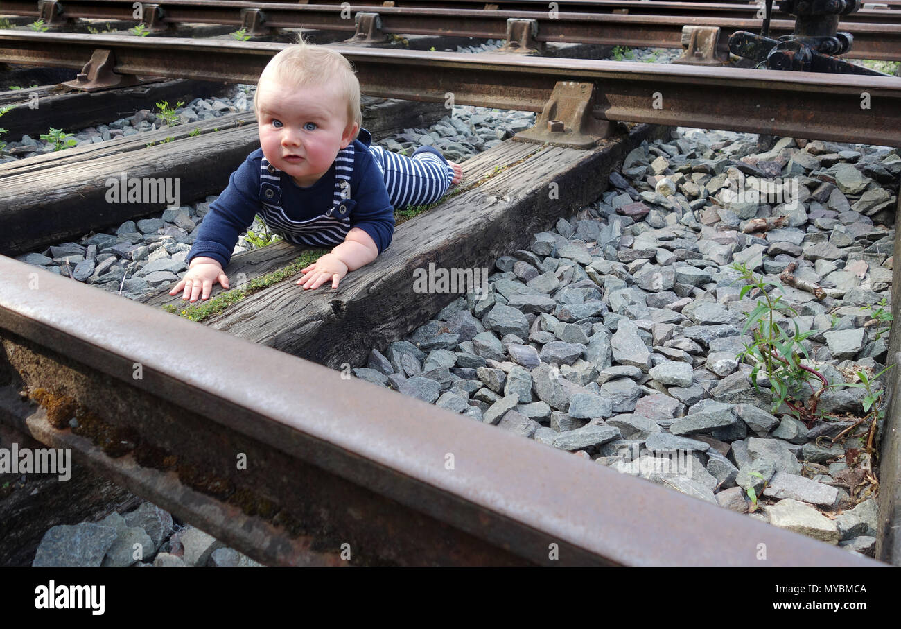 Child baby on disused railway line track Stock Photo