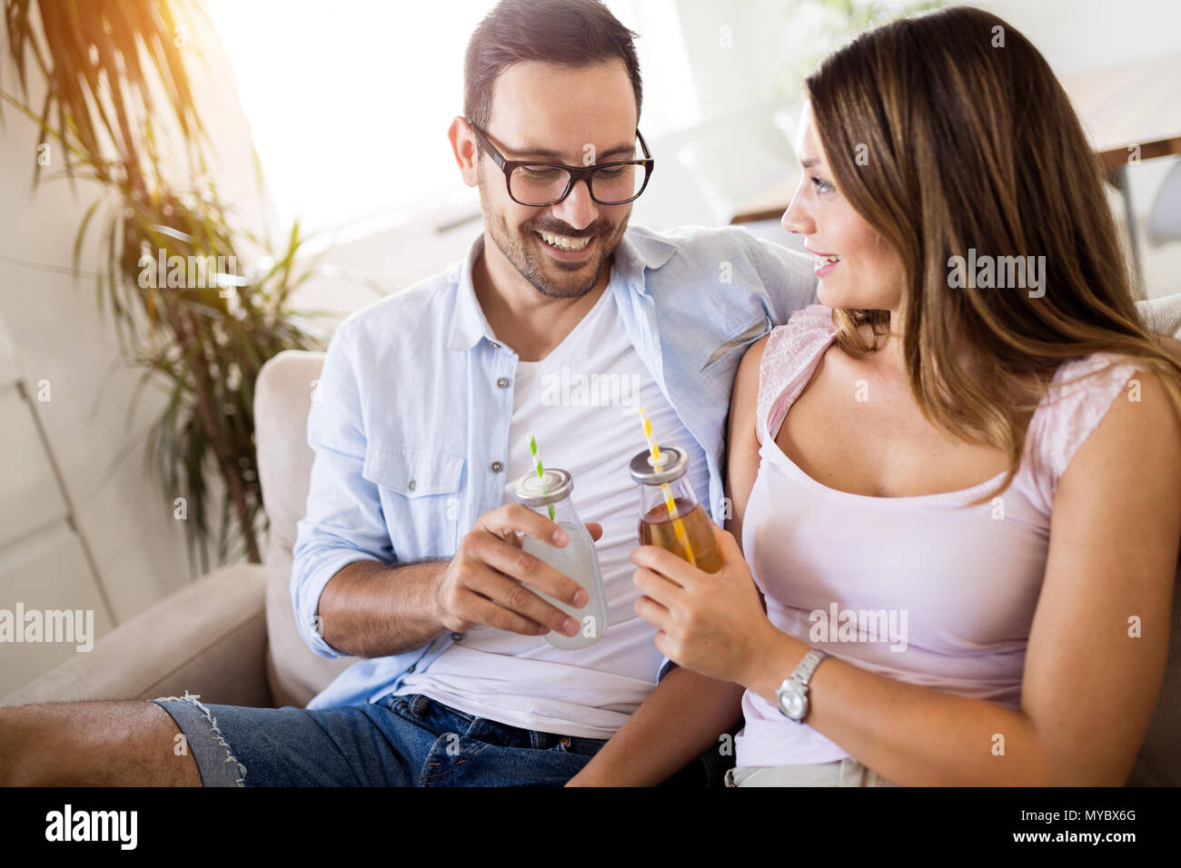 Happy attractive couple drinking together at home Stock Photo